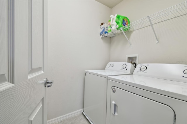 laundry area featuring washing machine and dryer, laundry area, and baseboards