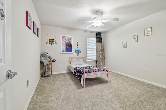 bedroom with carpet, ceiling fan, a textured ceiling, and baseboards