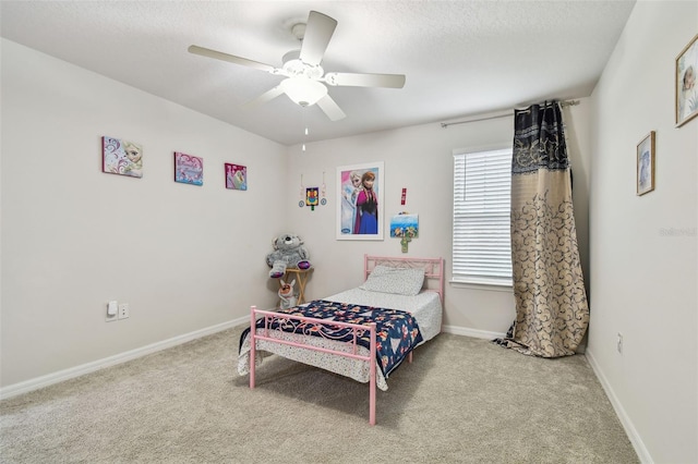 bedroom with carpet, baseboards, ceiling fan, and a textured ceiling