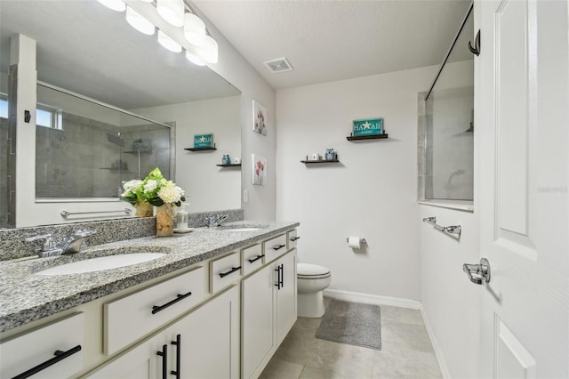 full bathroom with toilet, a shower stall, visible vents, and a sink