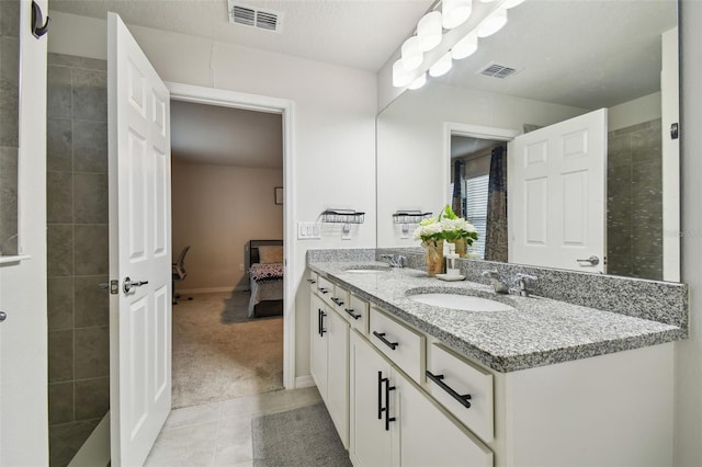 full bath featuring double vanity, a sink, and visible vents