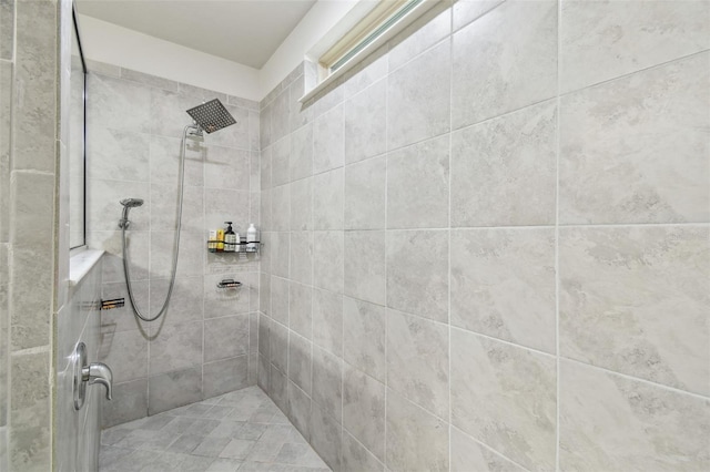 bathroom with a tile shower