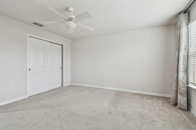 unfurnished bedroom with carpet floors, visible vents, and baseboards