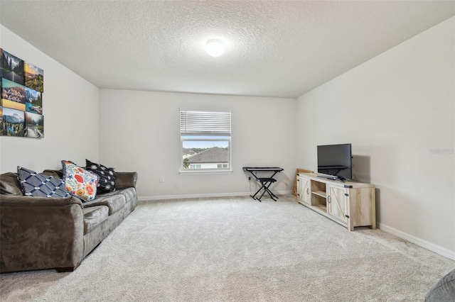 carpeted living area featuring a textured ceiling and baseboards