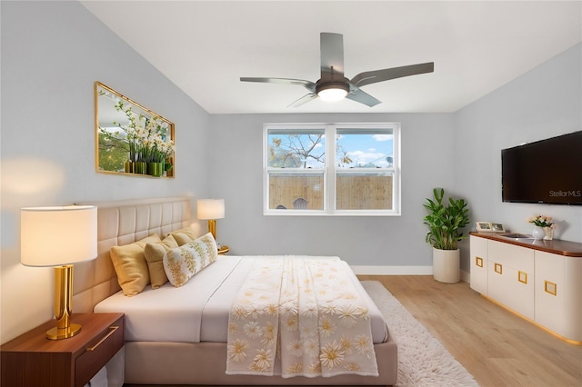 bedroom with ceiling fan, baseboards, and wood finished floors