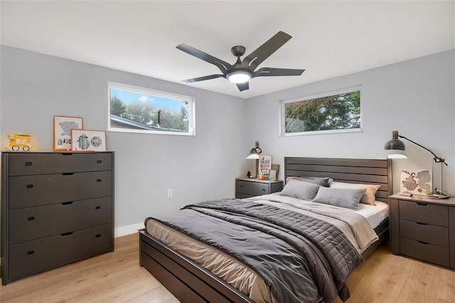 bedroom featuring baseboards, ceiling fan, and light wood finished floors