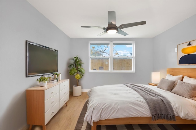 bedroom featuring light wood-style floors, ceiling fan, and baseboards