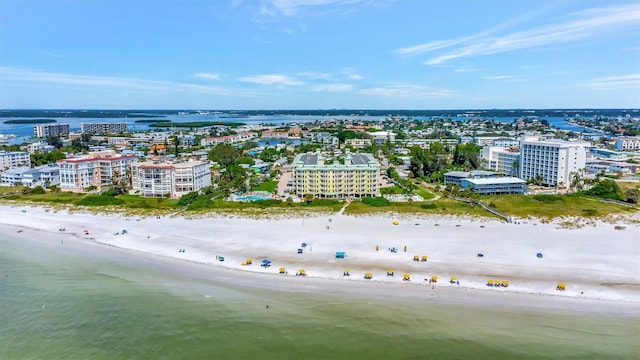 birds eye view of property featuring a water view, a view of city, and a beach view