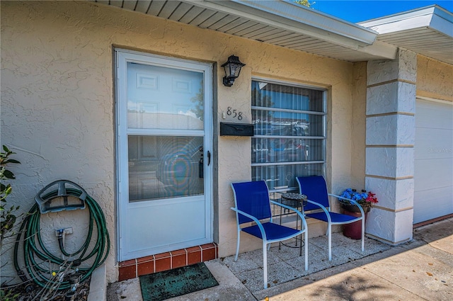 entrance to property with stucco siding