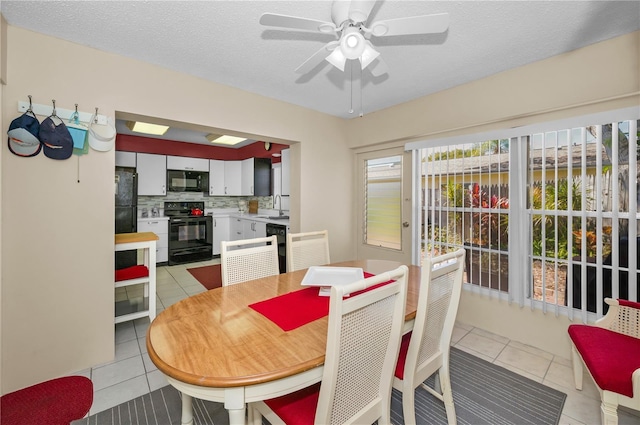 dining room featuring ceiling fan, a textured ceiling, and light tile patterned flooring