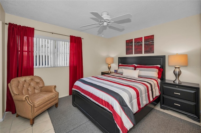 bedroom with a ceiling fan and a textured ceiling