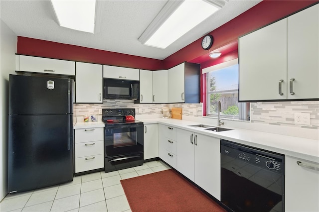 858 Cambridge Ct Unit 858, Dunedin, FL 34698 - kitchen featuring black appliances, light countertops, decorative backsplash, and light tile patterned floors
