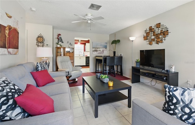858 Cambridge Ct Unit 858, Dunedin, FL 34698 - living area featuring ceiling fan, tile patterned floors, and a textured ceiling