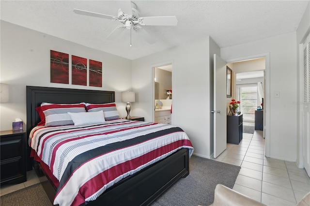858 Cambridge Ct Unit 858, Dunedin, FL 34698 - tiled bedroom featuring connected bathroom, a textured ceiling, and ceiling fan