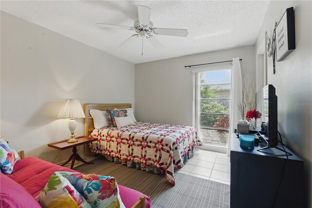 858 Cambridge Ct Unit 858, Dunedin, FL 34698 - bedroom featuring a ceiling fan, tile patterned flooring, and a textured ceiling