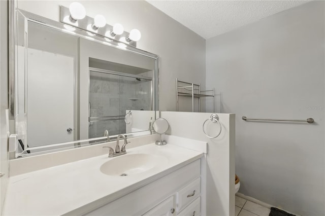 858 Cambridge Ct Unit 858, Dunedin, FL 34698 - bathroom featuring vanity, a textured ceiling, a shower with shower door, and tile patterned floors
