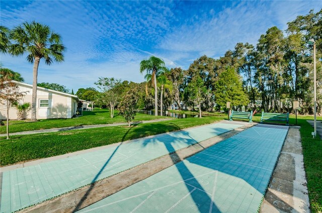 858 Cambridge Ct Unit 858, Dunedin, FL 34698 - view of home's community featuring shuffleboard, a lawn, and view of wooded area
