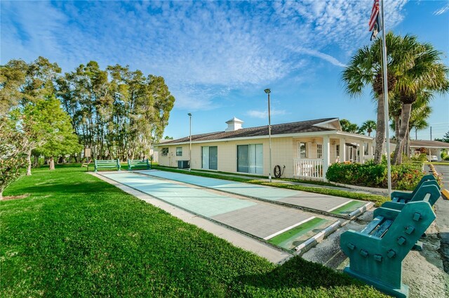 858 Cambridge Ct Unit 858, Dunedin, FL 34698 - back of house with a lawn and a chimney
