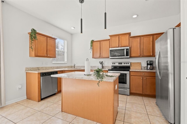 kitchen with brown cabinets, light tile patterned floors, a kitchen island, and stainless steel appliances