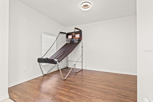 interior space featuring baseboards and wood finished floors