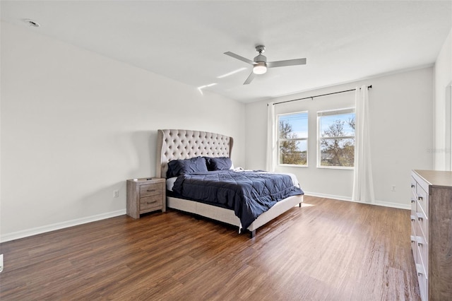 bedroom featuring ceiling fan, baseboards, and wood finished floors