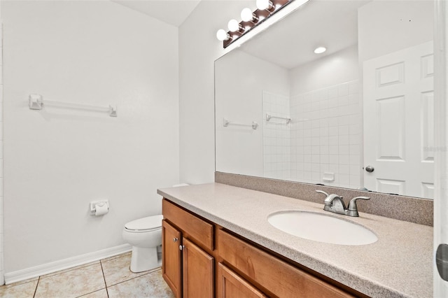 full bath featuring tile patterned floors, toilet, tiled shower, baseboards, and vanity