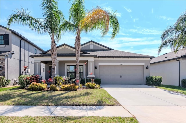 view of front of property featuring a garage, concrete driveway, and stucco siding