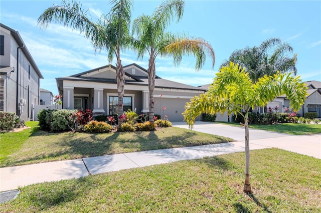 view of front facade featuring a garage, concrete driveway, and a front yard