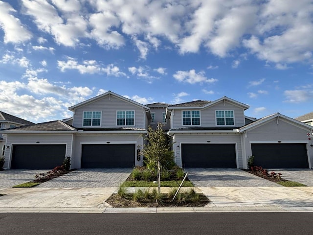 view of front of property with an attached garage and decorative driveway