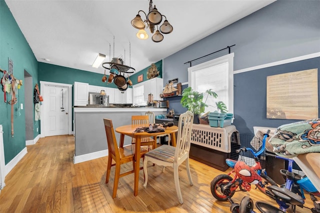 dining space featuring baseboards and light wood-style floors