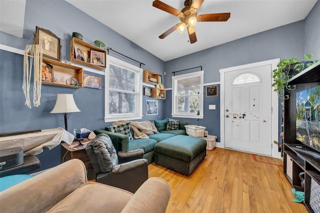 living area with ceiling fan and wood-type flooring