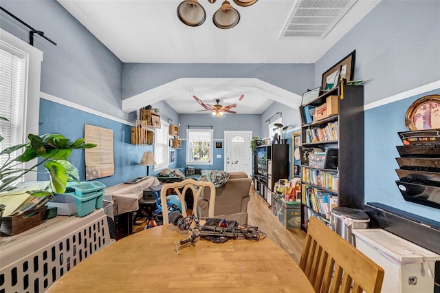 dining room featuring ceiling fan, visible vents, and wood finished floors