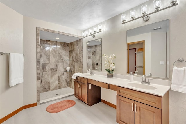 bathroom with double vanity, a sink, a walk in shower, and visible vents