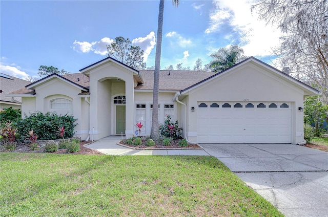 ranch-style house with a garage, concrete driveway, a front yard, and stucco siding