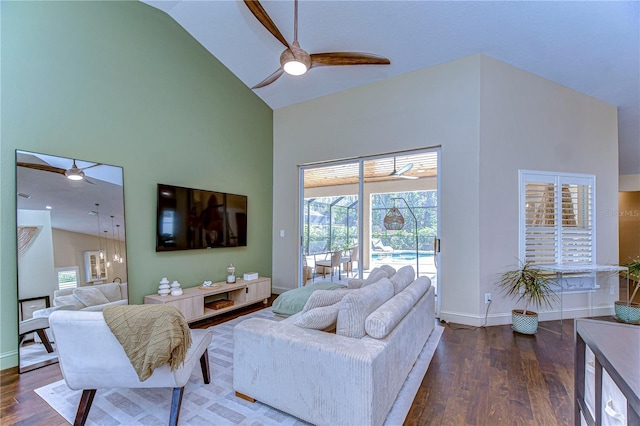 living area with ceiling fan, high vaulted ceiling, and wood finished floors