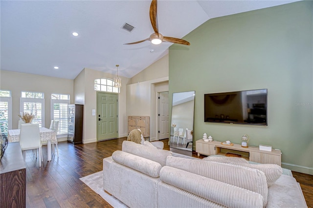 living room featuring baseboards, visible vents, dark wood finished floors, a ceiling fan, and high vaulted ceiling