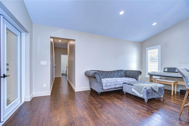 interior space with lofted ceiling, baseboards, wood finished floors, and recessed lighting