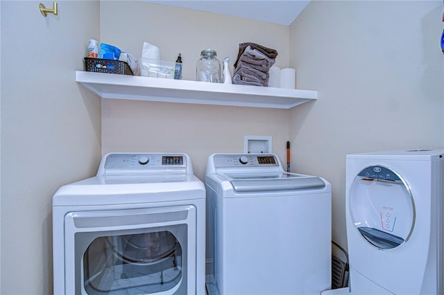 clothes washing area featuring laundry area and separate washer and dryer