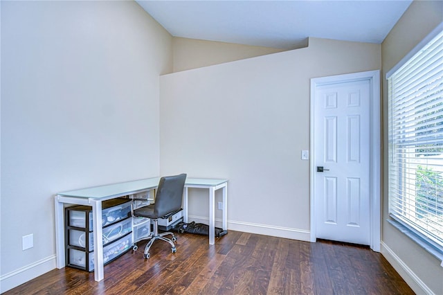 office space with lofted ceiling, baseboards, and wood finished floors