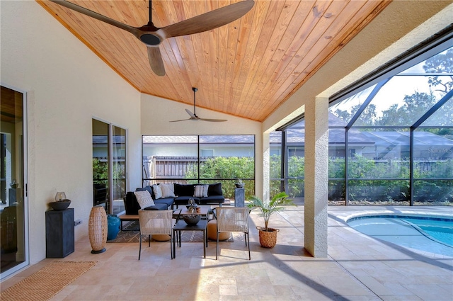 sunroom / solarium with lofted ceiling, wooden ceiling, and ceiling fan