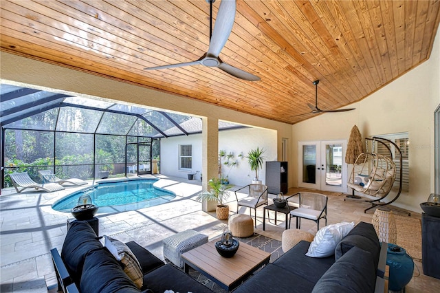 outdoor pool featuring ceiling fan, a lanai, french doors, a patio area, and an outdoor living space