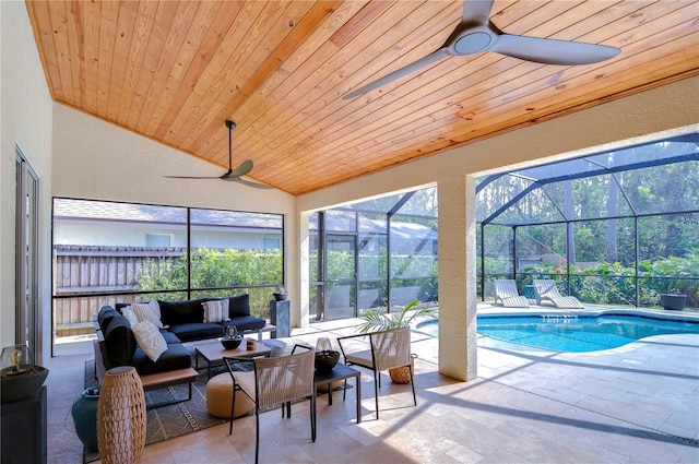 sunroom / solarium featuring a ceiling fan, wooden ceiling, and vaulted ceiling