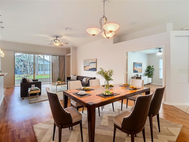 5351 Lookout Pass, Wesley Chapel, FL 33544 - dining room with baseboards, visible vents, ceiling fan with notable chandelier, and light wood finished floors