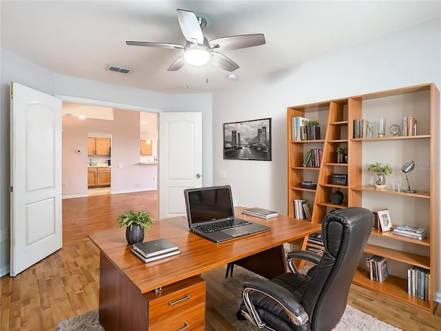 5351 Lookout Pass, Wesley Chapel, FL 33544 - home office featuring ceiling fan, light wood-style flooring, and visible vents
