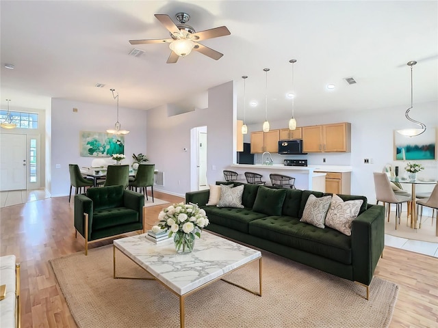 5351 Lookout Pass, Wesley Chapel, FL 33544 - living room with visible vents, ceiling fan, and light wood-style flooring