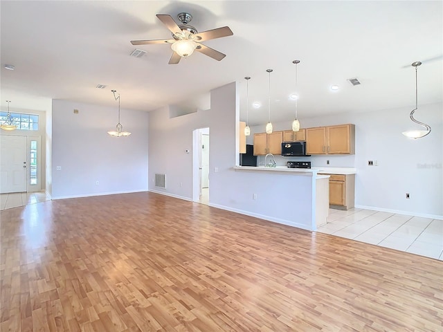 5351 Lookout Pass, Wesley Chapel, FL 33544 - unfurnished living room featuring light wood finished floors, visible vents, and ceiling fan with notable chandelier