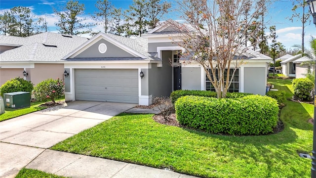 5351 Lookout Pass, Wesley Chapel, FL 33544 - view of front facade featuring a front lawn, a garage, a shingled roof, concrete driveway, and stucco siding
