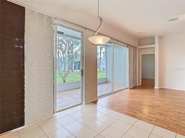 5351 Lookout Pass, Wesley Chapel, FL 33544 - unfurnished dining area with light wood-style floors, visible vents, and baseboards