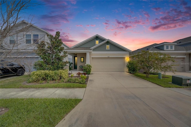 view of front facade with driveway, an attached garage, and stucco siding