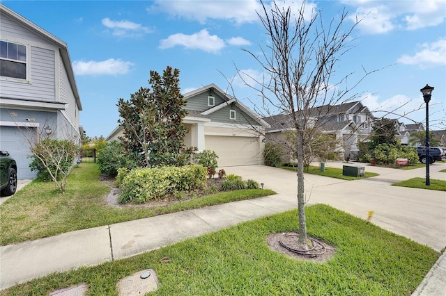 view of front of property with an attached garage, driveway, and a front yard